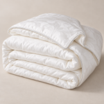 White Sigma Silk duvet with cotton jacquard cover, folded to show its soft layers and decorative edge