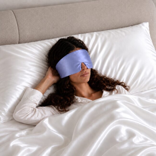 periwinkle blue--silk-filled-sleep-mask-on-model.jpg