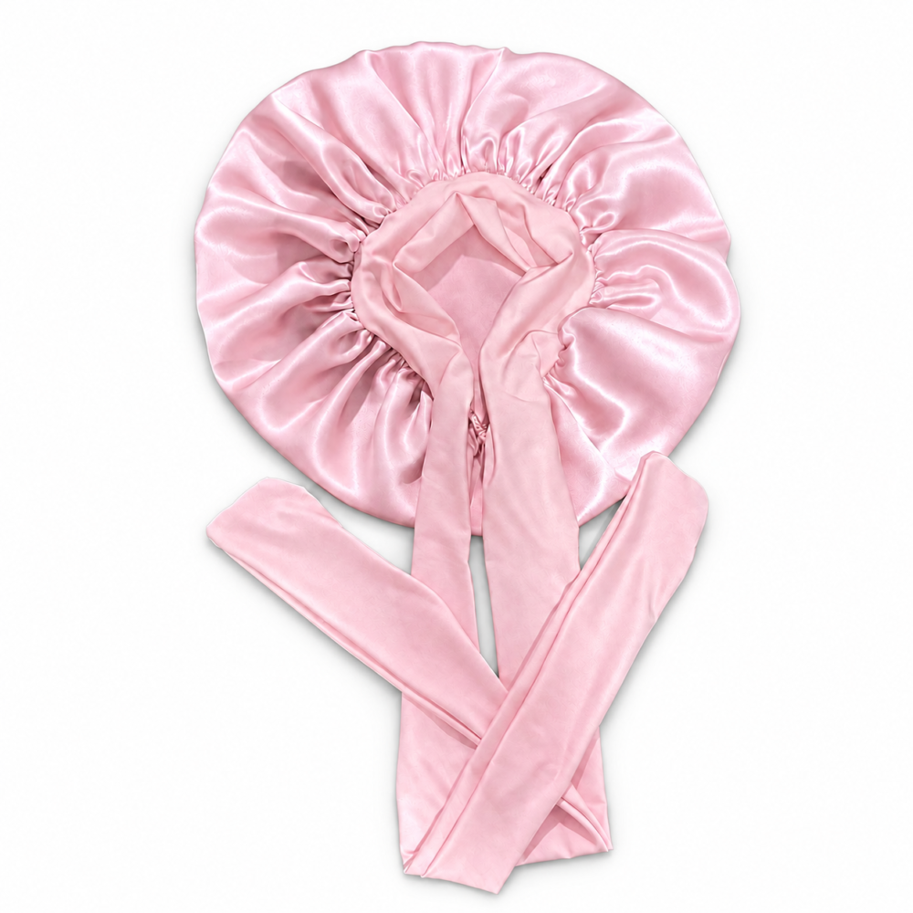 Ballet Pink silk bonnet with full ribbon ties on a white background