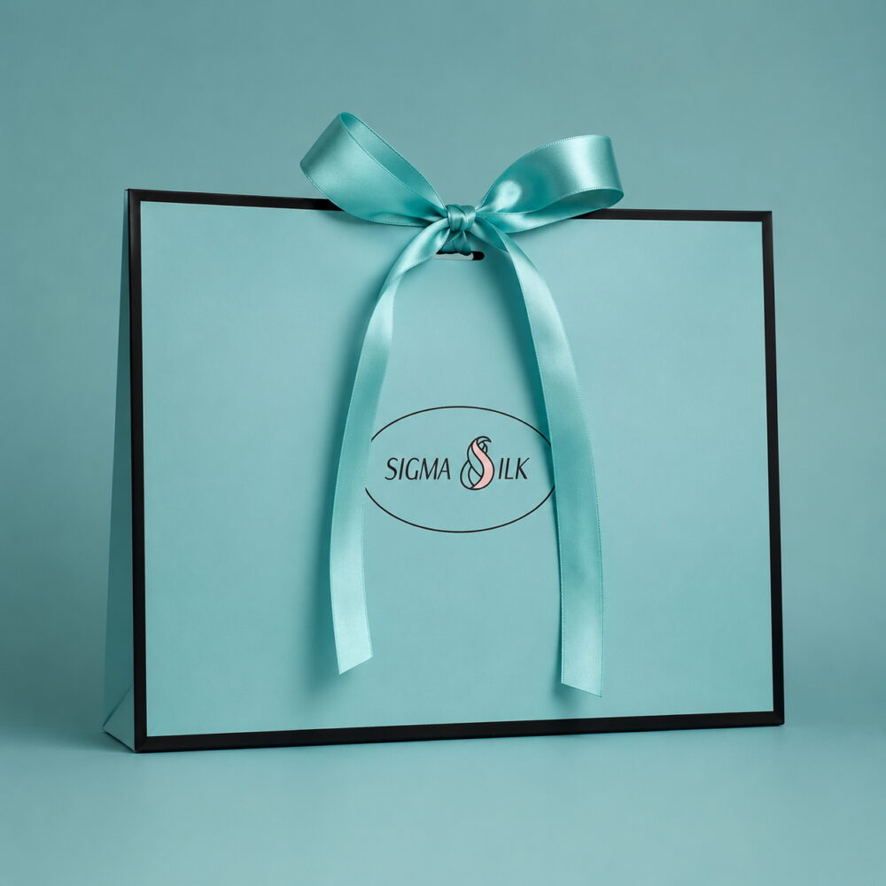 Turquoise Sigma Silk paper gift bag with a matching turquoise ribbon
