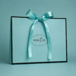 Turquoise Sigma Silk paper gift bag with a matching turquoise ribbon